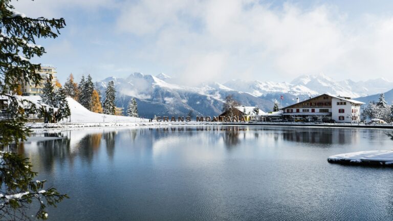 Crans-Montana resort guide — lake reflection and snow-covered Valais Alps in winter